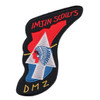 Embroidered Imjin Scouts DMZ patch in freeform arrowhead shape with black field, red and blue 2nd Infantry Division arrow insignia, silver Indian Head on triangle, crossed gold lances, red arc lettering reading IMJIN SCOUTS and gold DMZ at base.