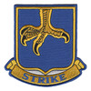 Blue shield patch with a gold eagle's claw coming down from the top, talons spread and tipped in black, above a gold scroll reading STRIKE in blue letters for the 502nd Infantry Regiment.