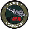 Sandy 1 CSAR A-10 patch, circular olive and black with white Warthog over downed pilot silhouette, So Others May Live in red text, CombatSAR