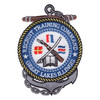 Recruit Training Command Great Lakes Illinois patch with a gray anchor and brown stock behind a rope-ringed blue medallion holding a crossed rifle and cutlass, an open book and three signal flags.