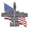 Embroidered patch of a gray A-10 Thunderbolt II seen from above over a waving American flag, cut to the jet's outline.