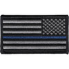 Rectangular embroidered American flag patch in subdued gray and black with a single thin blue stripe through the stripes field, reversed orientation for right-shoulder wear, black merrow border.