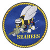 Round 7 inch Seabees back patch showing the fighting bee in a white Dixie cup holding a submachine gun, wrench and hammer on a royal blue field inside a gold rope border, with SEABEES in gold stencil letters.