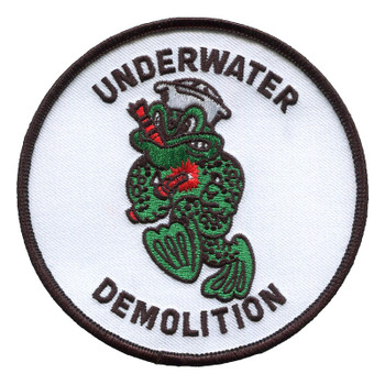 Round white Underwater Demolition patch with a green spotted frog in a gray helmet, dive mask and swim fins carrying demolition charges with a lit fuse, inside a dark merrowed border.