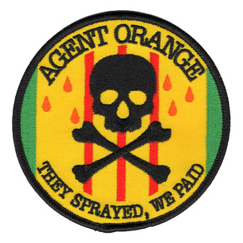 Round Agent Orange patch with a black skull and crossbones and orange droplets on Vietnam Service ribbon colors, reading They Sprayed, We Paid.