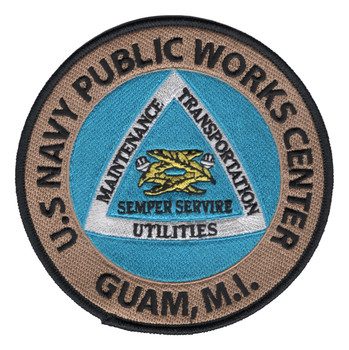 Round embroidered patch for U.S. Navy Public Works Center Guam, featuring a turquoise field with a silver-bordered white triangle divided into Maintenance, Transportation, and Utilities sections, a central gold and olive tool emblem, the motto Semper Servire, and a tan outer ring with black merrowed border.