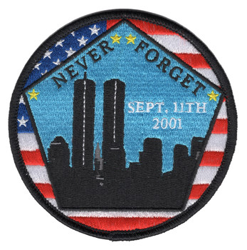 Circular embroidered patch with a black silhouette of the New York City skyline and Twin Towers against a blue sky, "NEVER FORGET" arched in white at top, "SEPT. 11TH 2001" in the center, American flag pentagon border with blue stars and red stripes, yellow accent stars, black outer merrow ring.