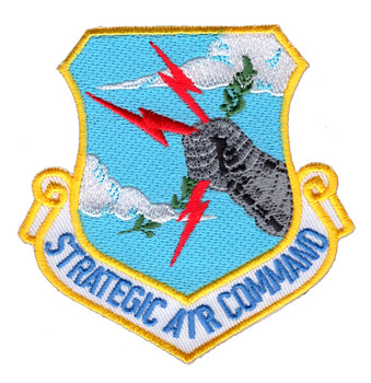 Embroidered Strategic Air Command shield patch with yellow merrowed border, sky-blue field, gray armored fist gripping three red lightning bolts, white cloud imagery, and white scroll banner reading Strategic Air Command in blue lettering.