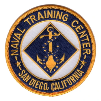 Round Naval Training Center San Diego, California patch with a gold anchor wound with navy and gold line inside a navy diamond on a white field, a navy ring of gold lettering and a gold merrowed border.
