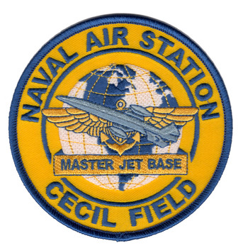 Round patch with gold background, blue merrowed border, text reading Naval Air Station and Cecil Field, globe with gray jet aircraft and gold wings over anchor, Master Jet Base ribbon at center