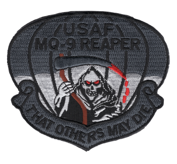 Badge-shaped subdued gray embroidered patch with "USAF MQ-9 REAPER" at top, a Grim Reaper with glowing red eyes holding a red scythe at center, parachute canopy behind, and "That Others May Die" scroll at bottom, in dark gray with red accents.