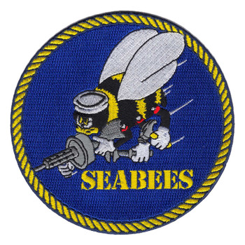 Round royal blue Navy Seabees patch with a gold rope border and the flying bee in a white sailor's dixie cup holding a submachine gun, hammer and wrench above gold stencil SEABEES lettering.
