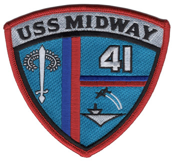 USS Midway shield patch with a red merrowed border, USS MIDWAY on a silver band, a white sword, the hull number 41 and a carrier launching a jet on a teal field.