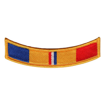Arched tab patch with a gold merrowed edge in Combat Action Ribbon colors: navy blue, gold, a narrow red, white and blue center, gold and red.
