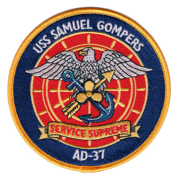 Round embroidered patch for USS Samuel Gompers AD-37 featuring a spread-winged bald eagle over crossed anchor and lightning bolt on a red ship's wheel field, with the motto SERVICE SUPREME on a gold banner, gold merrowed border on navy blue.
