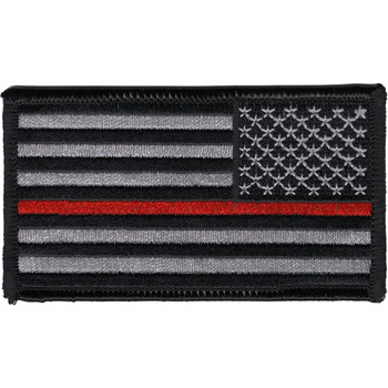 Rectangular embroidered American flag patch in subdued gray and black with a single thin red stripe through the stripes field, reversed orientation for right-shoulder wear, black merrow border.