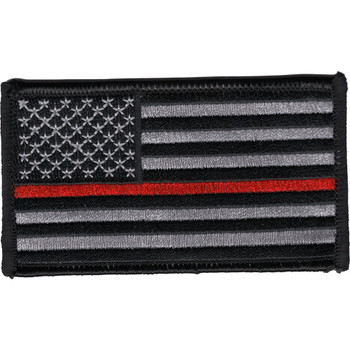 Rectangular embroidered American flag patch in subdued gray and black with a single thin red stripe through the stripes field, standard facing orientation with stars on the left, black merrow border.