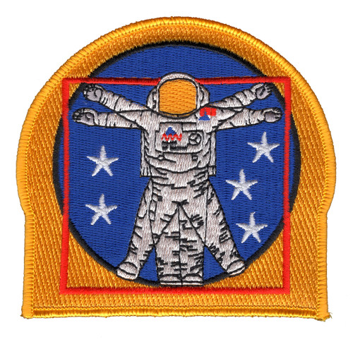 Gold-bordered tomb-shaped patch featuring silver EVA astronaut in spacesuit with arms outstretched, surrounded by five white stars on blue field with red inner border and gold sun above helmet.
