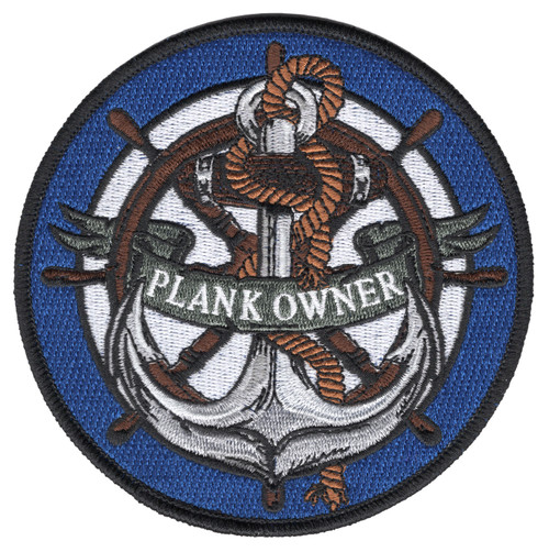 Round embroidered Plank Owner patch with a silver fouled anchor over a brown ships wheel wrapped in rope, a Plank Owner banner across the center, a royal blue ring, and a black merrowed border.