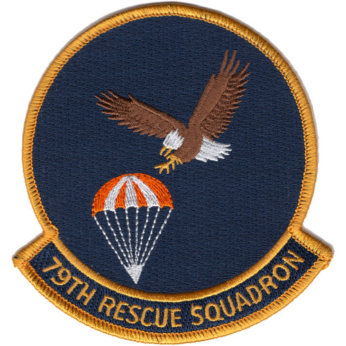 Circular embroidered patch with navy blue field, gold border, bald eagle in diving attitude toward an orange and white parachute, and "79TH RESCUE SQUADRON" gold scroll at bottom.