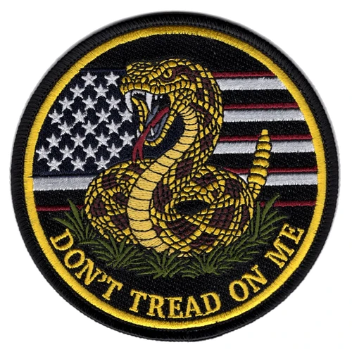 Round black bordered patch with a coiled gold and maroon rattlesnake, rattle raised, over a blacked out American flag, with DON'T TREAD ON ME arched in gold along the bottom.