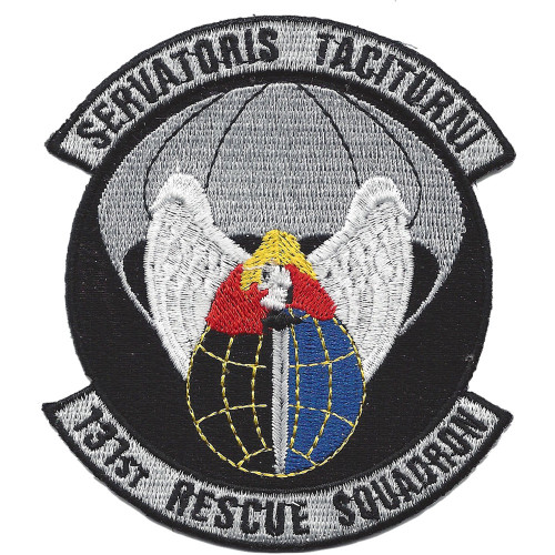 Circular embroidered patch with black field, gray border, gray scrolls reading "Servatoris Taciturn" at top and "131st Rescue Squadron" at bottom, winged angel over a blue and red globe with parachute canopy above.