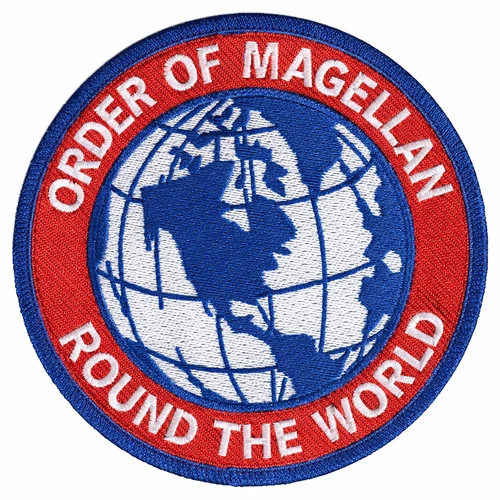 Round embroidered Order of Magellan patch with a blue and white globe centered on the Americas, a red ring bearing Order of Magellan and Round the World in white letters, inside a blue merrowed border.