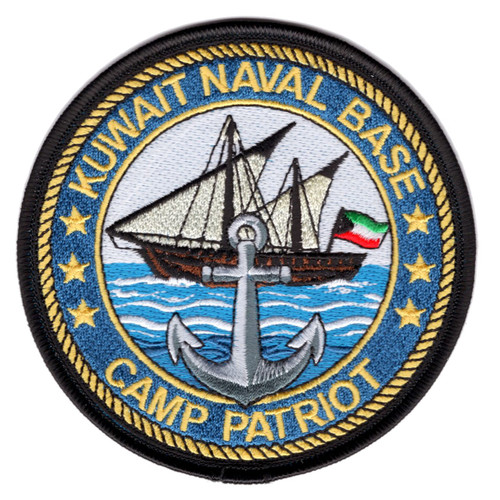 Round embroidered patch with black merrowed border and rope-twist ring, depicting a Kuwaiti dhow under sail flying the Kuwaiti flag over blue Gulf waters with a gray naval anchor in the foreground, gold text reading Kuwait Naval Base and Camp Patriot, surrounded by gold stars on a blue border.