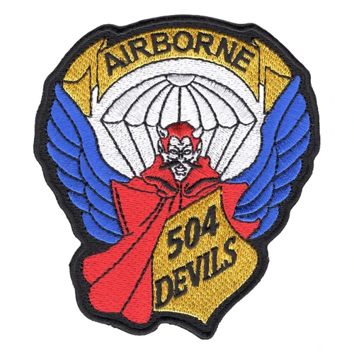 504th Parachute Infantry Regiment patch with a red devil in a red cape under a white parachute canopy, blue wings at the sides, AIRBORNE on a gold banner above and 504 DEVILS on a gold panel.