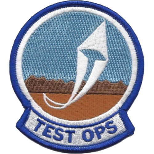 Circular patch with '445th' designation and flight test insignia, featuring muted blue and gray colors with operational emblem.