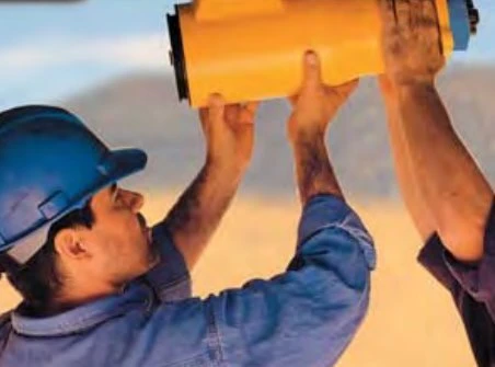 Technicians mounting an Ingersoll Rand ST650BP03R31 turbine air starter on a Caterpillar 3512 engine in a mine haul truck