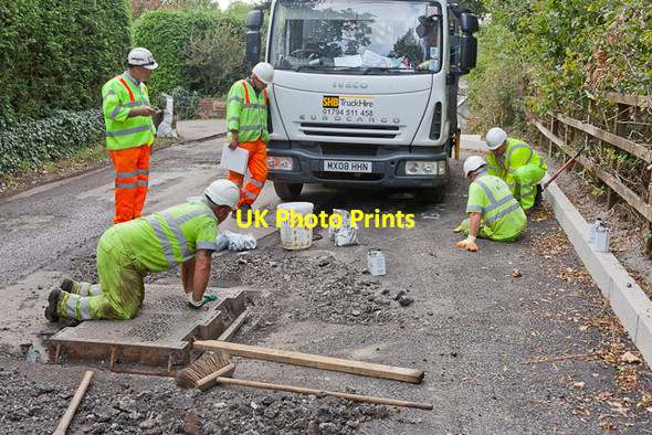 Photo 6"x4" Contractors reset a manhole cover before resurfacing Hensting Lane Hensting c2011