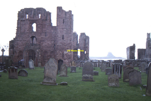 Photo 6"x4" Lindisfarne Priory, with a distant view of the Castle Holy Island\/NU1241 c1996