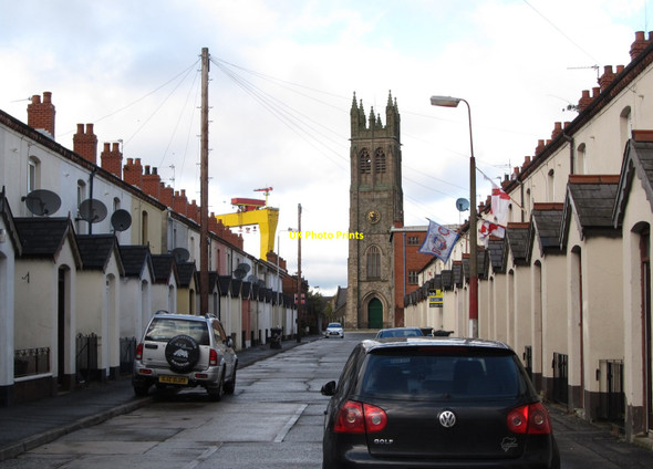 Photo 6"x4" The steeple of St Patrick's CoI and one of Harland & Wolff's cranes compete for attention at the end of  Parker Street Belfast c2014