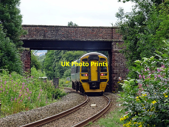 Photo 6"x4" An Aberystwyth bound train passes the site of Meole Brace station Shrewsbury c2016