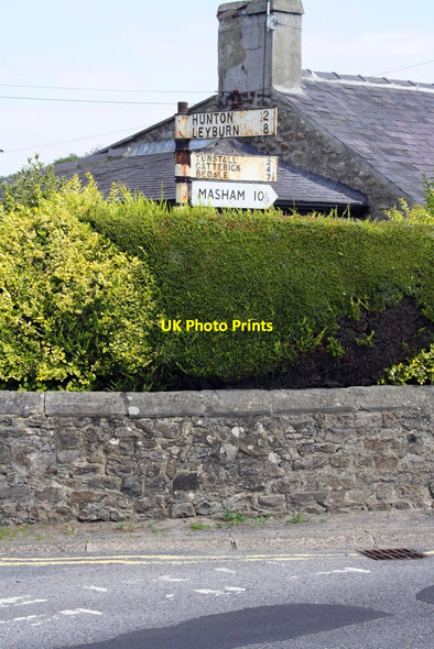 Photo 6"x4" Signpost in garden of house at junction of Scotton Road, Bedale Road and Hunton Road Scotton\/SE1896 c2016
