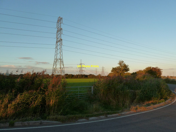 Photo 6"x4" Gate to field, a bend in the road, and pylon scene beyond, near Whitson Whitson c2010