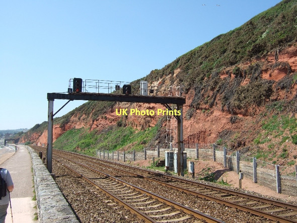 Photo 6"x4" Signal gantry over line below cliffs east of Dawlish Dawlish c2011