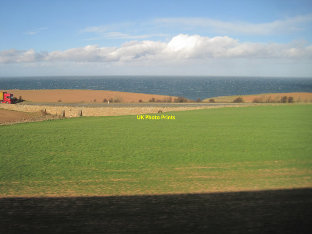 Photo 6"x4" View from a Newcastle-Edinburgh train - towards the A1 and the coast Thorntonloch c2015