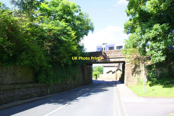 Photo 6"x4" Carlisle to Leeds train passes over Station Road bridge Settle c2017