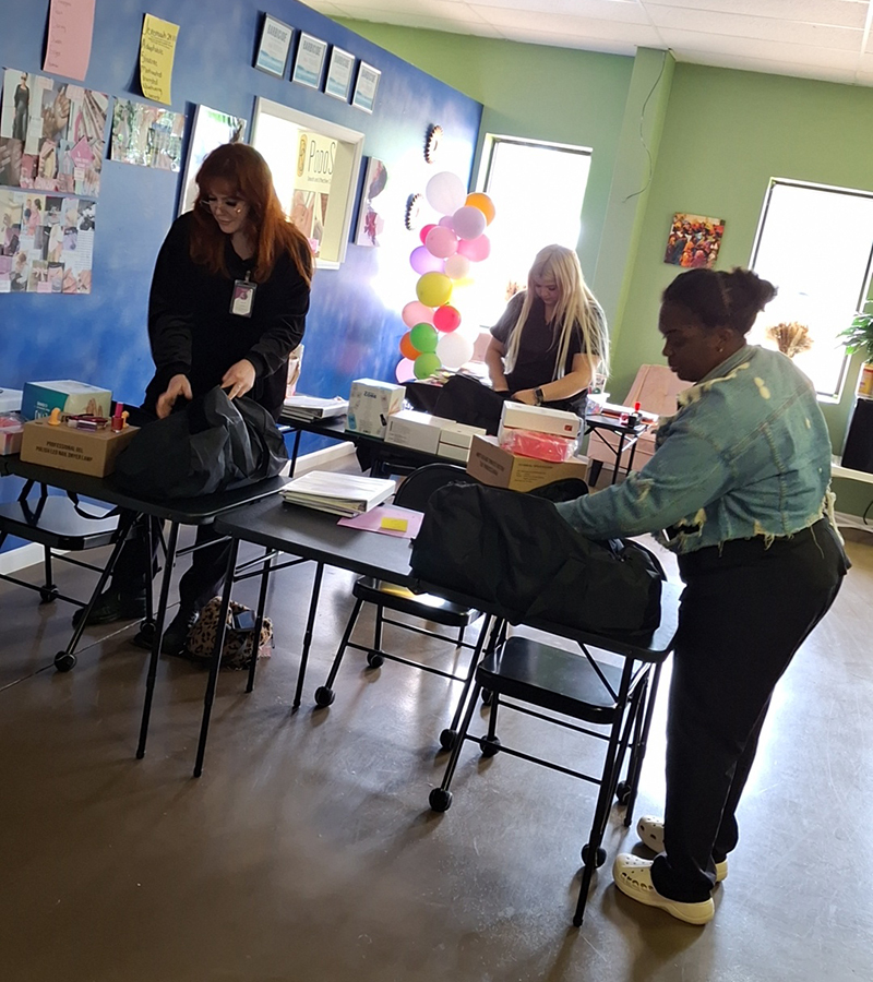 nail techs unpacking nail kit bags