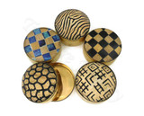 Each lid has a different design, including:

Zebra-like wavy stripes (top)

Blue-and-gold checkerboard (left)

Black-and-gold checkerboard (right)

Honeycomb / giraffe-spot pattern (bottom left)

Abstract geometric symbols (bottom right)