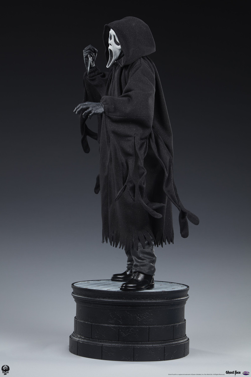 cloaked figure statue