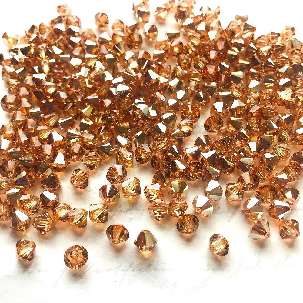 swarovski-crystal-5328-bicone-beads-crystal-metallic-sunshine-83707-43870.jpg