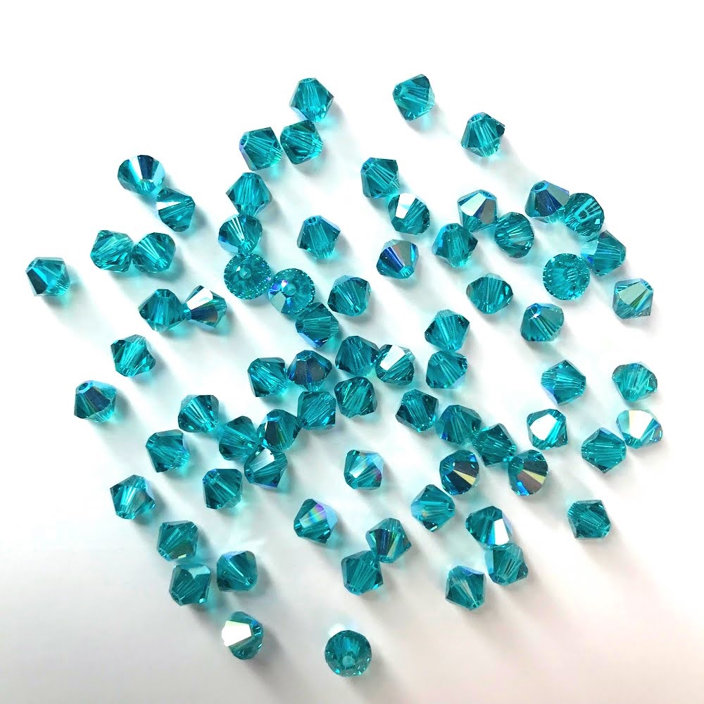 swarovski-crystal-blue-zircon-ab-bicone-beads.jpg