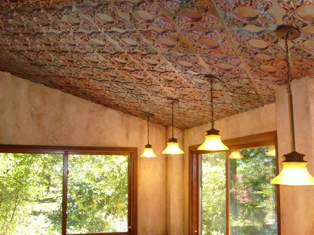 Cathedral ceiling with 3 lights and faux finished ceiling tiles.