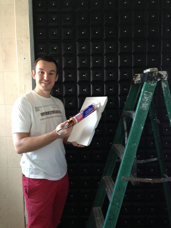 Milan Jara the co-founder of Decorative Ceiling Tiles applying adhesive to a faux leather tile at Vanilla Ice Project Seson 4