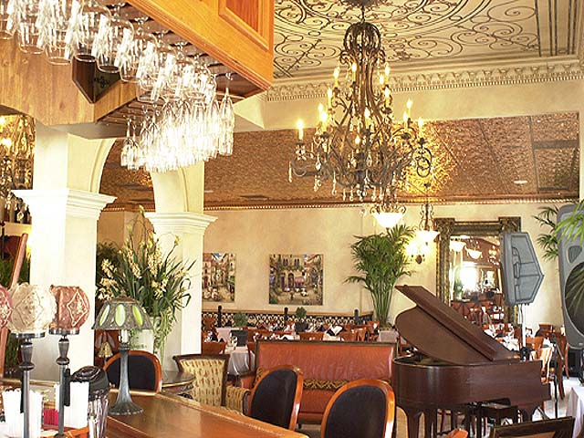 Lovely looking restaurant with piano, ceiling murals, chandelier and real copper celing tiles.