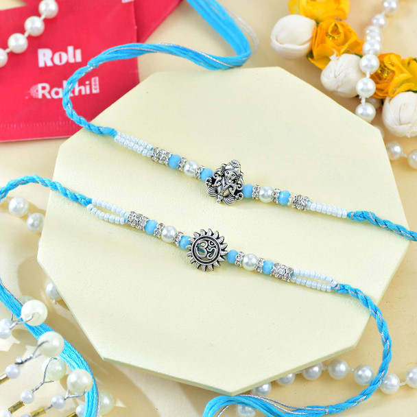 Ganesh And Suriya Set Of Two Rakhi With Kaju Katli