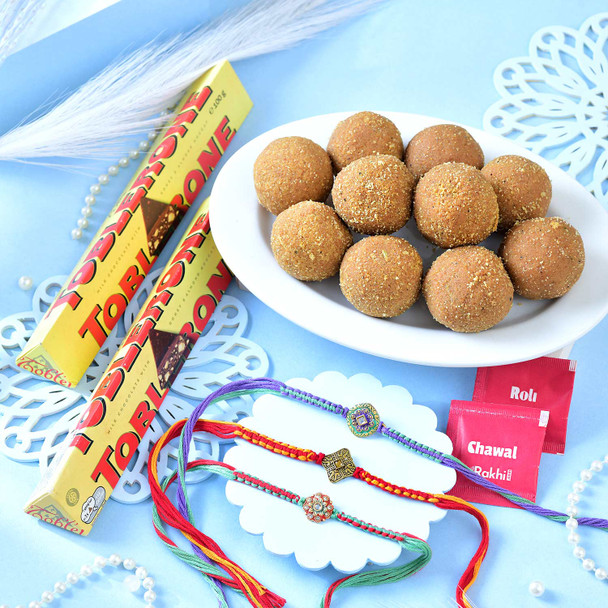 Set Of Three Traditional Rakhi With Besan Laddu & Toblerone Chocolates